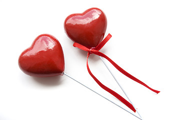 Image showing Two plastic souvenir hearts isolated