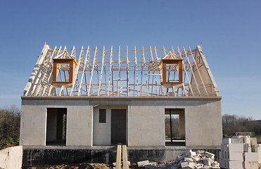 Image showing house under construction with the roof structure of wood