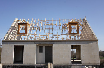 Image showing house under construction with the roof structure of wood