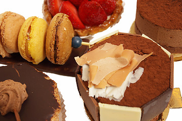 Image showing assortment of small cakes on a white background