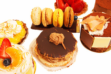 Image showing assortment of small cakes on a white background