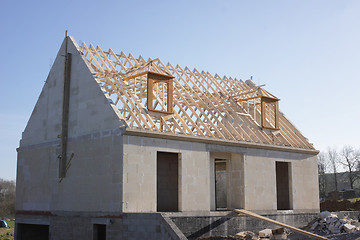 Image showing house under construction with the roof structure of wood