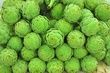 Image showing large fresh artichokes on a market stall
