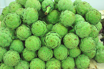 Image showing large fresh artichokes on a market stall