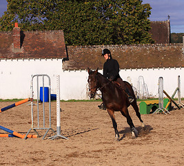 Image showing pretty young woman rider in a competition riding