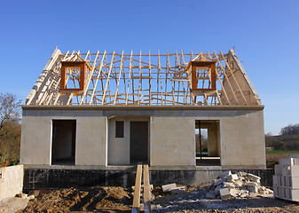 Image showing house under construction with the roof structure of wood