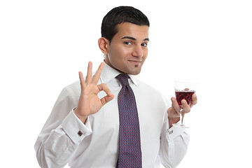 Image showing A man with wine shows approval or excellence