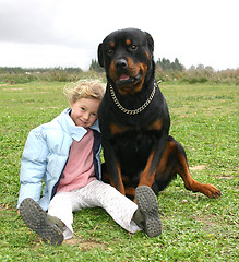 Image showing rottweiler and little girl