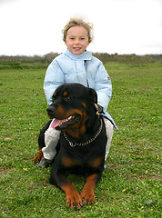 Image showing rottweiler and little girl