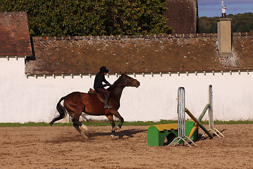 Image showing pretty young woman rider in a competition riding