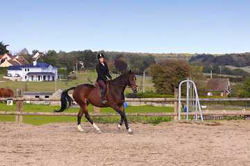 Image showing pretty young woman rider in a competition riding