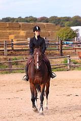 Image showing pretty young woman rider in a competition riding