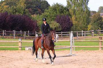 Image showing pretty young woman rider in a competition riding