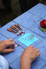 Image showing Process of lace-making with bobbins 