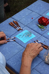 Image showing Process of lace-making with bobbins 