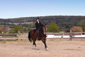 Image showing pretty young woman rider in a competition riding