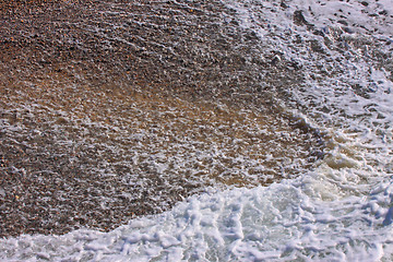 Image showing wave and foam on a pebble beach in Etretat