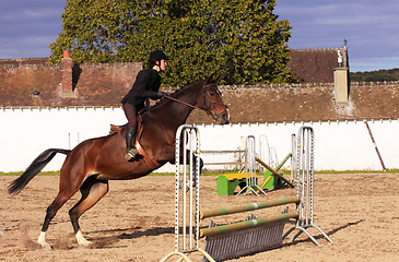 Image showing pretty young woman rider in a competition riding