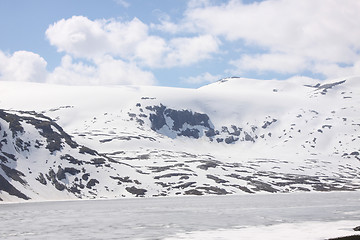 Image showing frozen lake and snowy mountains in norway