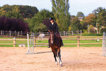 Image showing pretty young woman rider in a competition riding