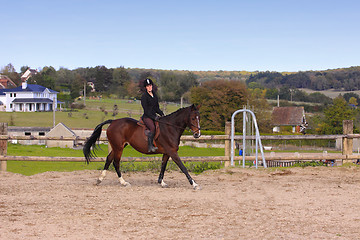 Image showing pretty young woman rider in a competition riding