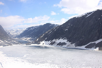 Image showing frozen lake and snowy mountains in norway