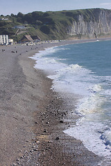 Image showing wave and foam on a pebble beach in Etretat