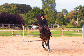 Image showing pretty young woman rider in a competition riding