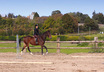 Image showing pretty young woman rider in a competition riding