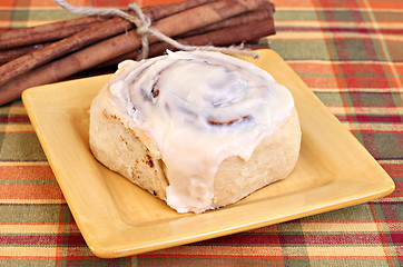 Image showing Cinnamon Bun and cinnamon sticks