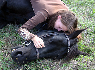 Image showing horse laid down and riding girl