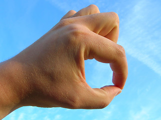 Image showing Hand on blue sky