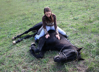 Image showing horse laid down and riding girl