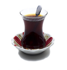 Image showing Brewed tea mixed with sugar spoon
