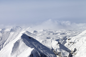 Image showing Snowy mountains in clouds