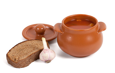 Image showing Soup in clay pot with bread and garlic