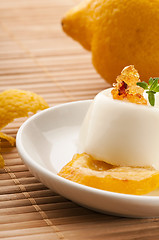 Image showing Vanilla Panna Cotta Dessert with lemon and fresh herbs