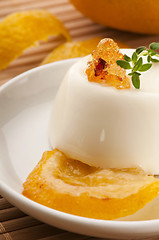 Image showing Vanilla Panna Cotta Dessert with lemon and fresh herbs