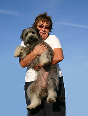 Image showing Pyrenean sheepdog and senior woman