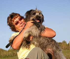 Image showing Pyrenean sheepdog and senior woman