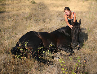 Image showing horse laid down and riding girl