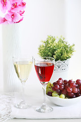 Image showing Two glasses of wine with grapes