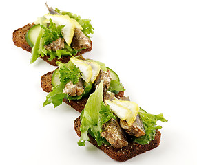 Image showing Three smoked sardines sandwiches