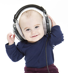 Image showing young child with ear-phones listening to music