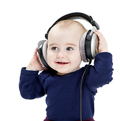 Image showing young child with ear-phones listening to music