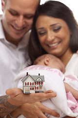 Image showing Mixed Race Family with Small Model House