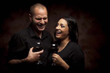Image showing Happy Mixed Race Couple Holding Wine Glasses