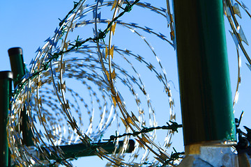 Image showing barbed wire against blue sky 