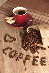 Image showing Grains of coffee on a wooden surface