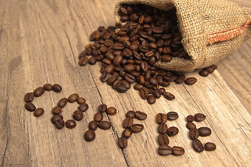 Image showing Grains of coffee on a wooden surface
